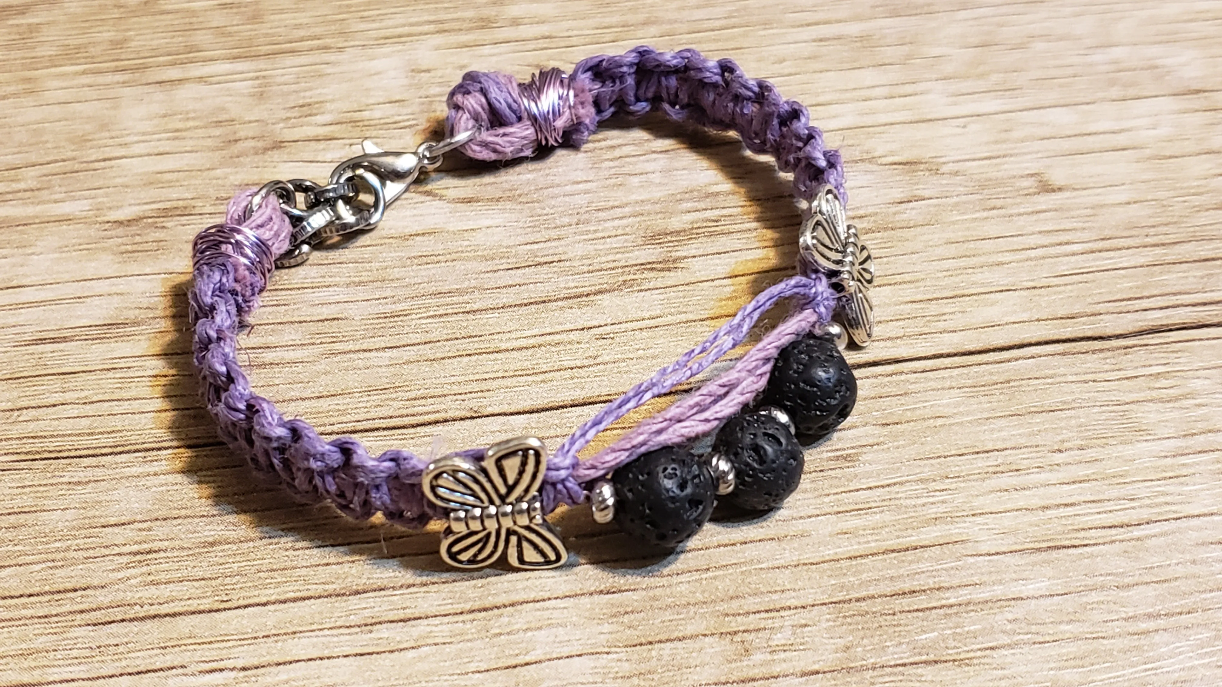 Purple Natural Hemp Bracelet with Lava Rocks and Silver Plated Butterly Accents. Adjustable Non Tarnish Chain with Lobster Claw Clasp